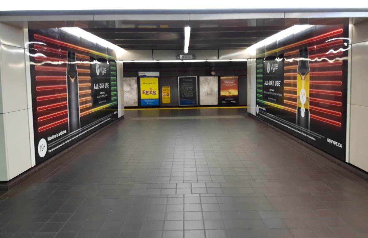 Ads for vape products displayed in the underground corridors of Burrard SkyTrain station in Vancouver.