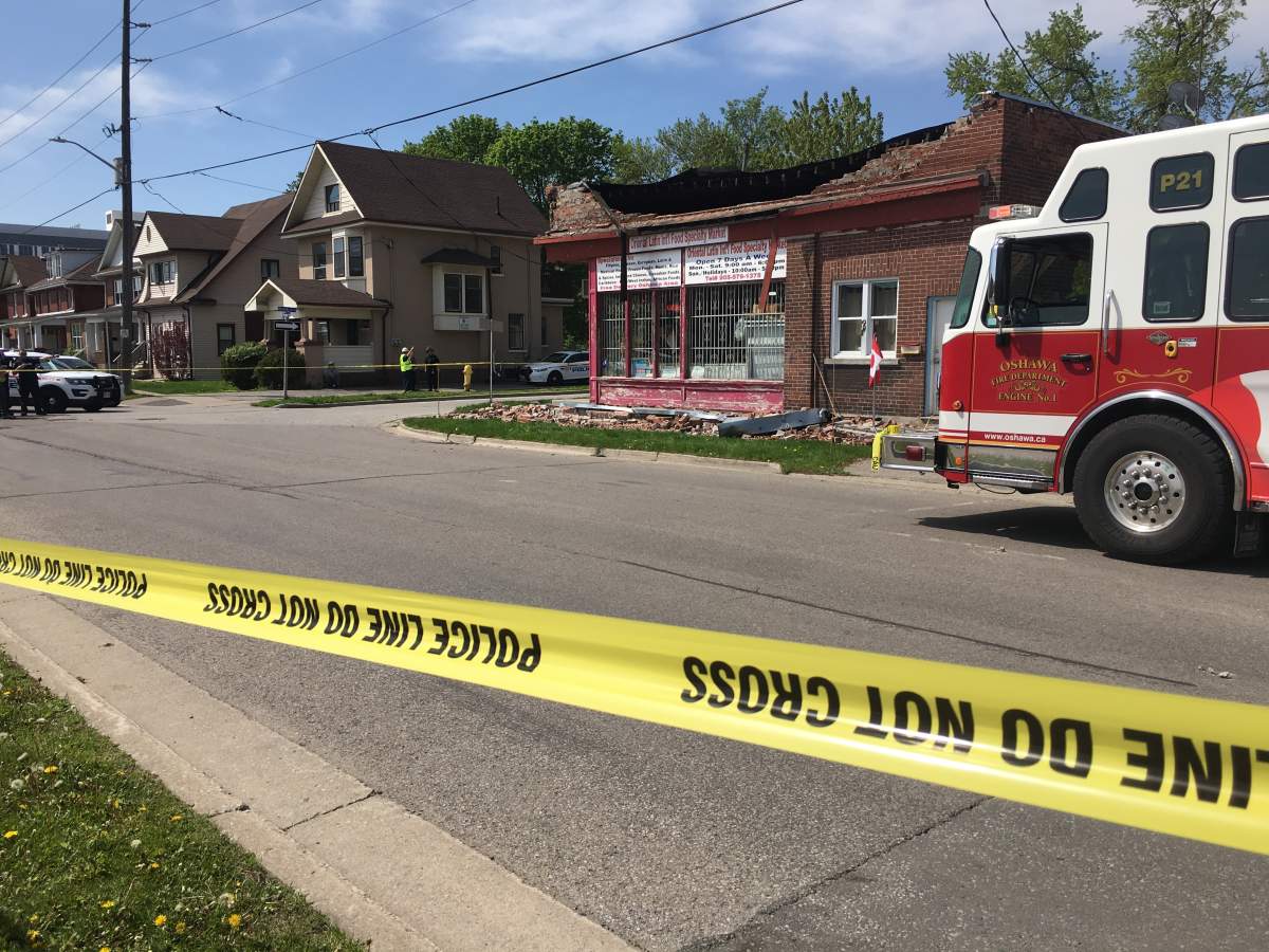 Emergency crews block off scene after police say a man fell off the roof of a storefront.