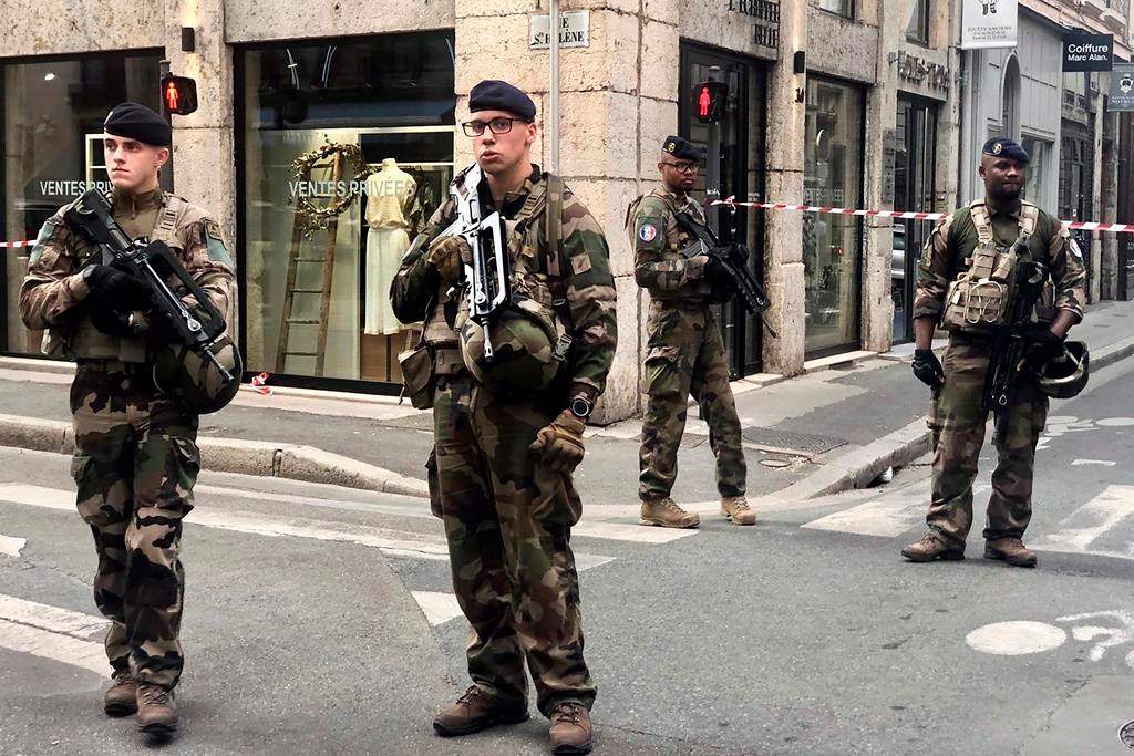 Soldiers of French antiterrorist plan “Vigipirate Mission”, secure the access near the site of a suspected bomb attack in central Lyon, Friday May, 24, 2019.