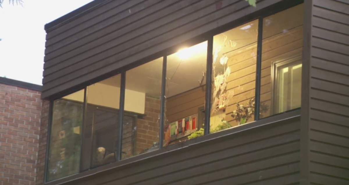The broken window a man was trying to climb from when he fell and was seriously injured in June. 