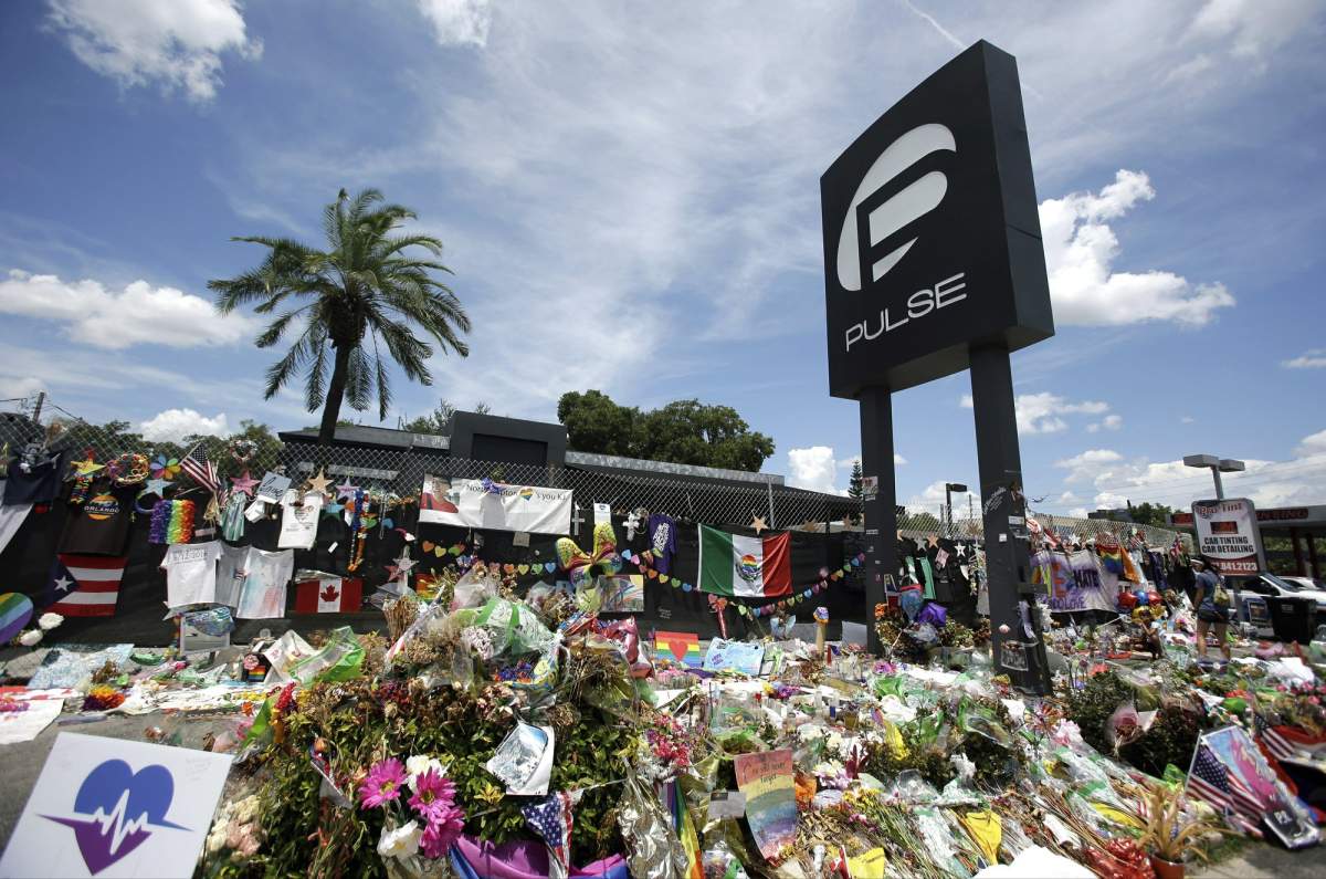 In this July 11, 2016, file photo, a makeshift memorial continues to grow outside the Pulse nightclub the day before the one-month anniversary of a mass shooting at the venue in Orlando, Fla.