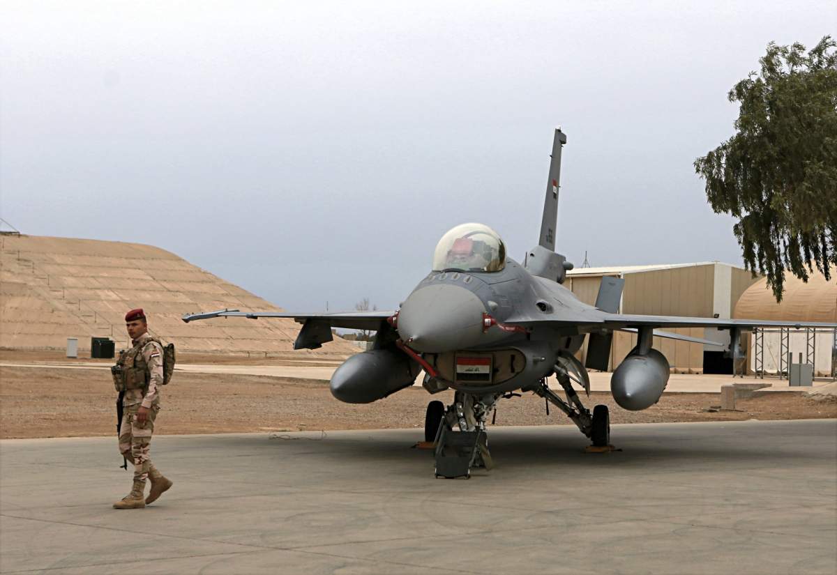 FILE - in this Tuesday, Feb. 13, 2018 file photo, an Iraqi army soldier stand guard near a U.S.- made Iraqi Air Force F-16 fighter jet at the Balad Air Base, Iraq. 
