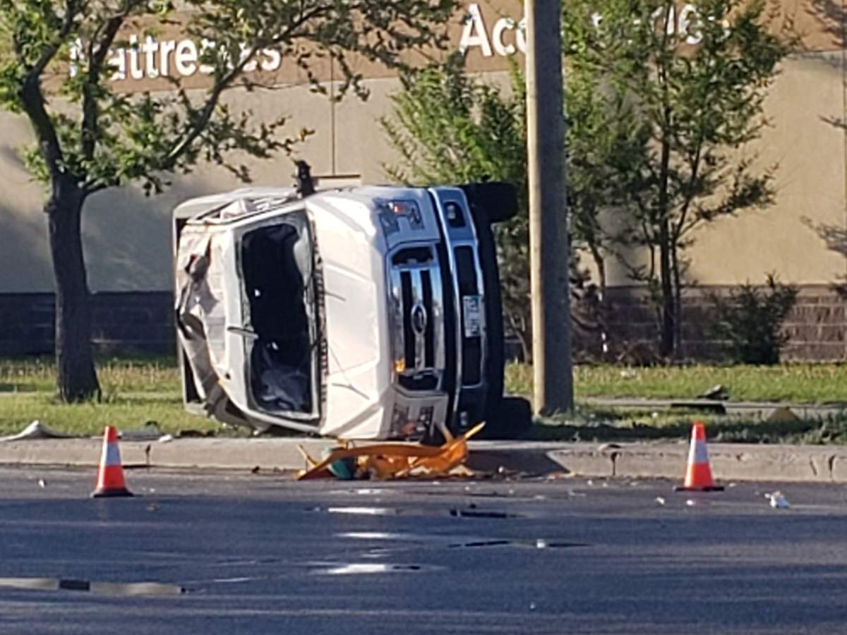 A white truck rests on its side after a collision with a taxicab Wednesday morning.