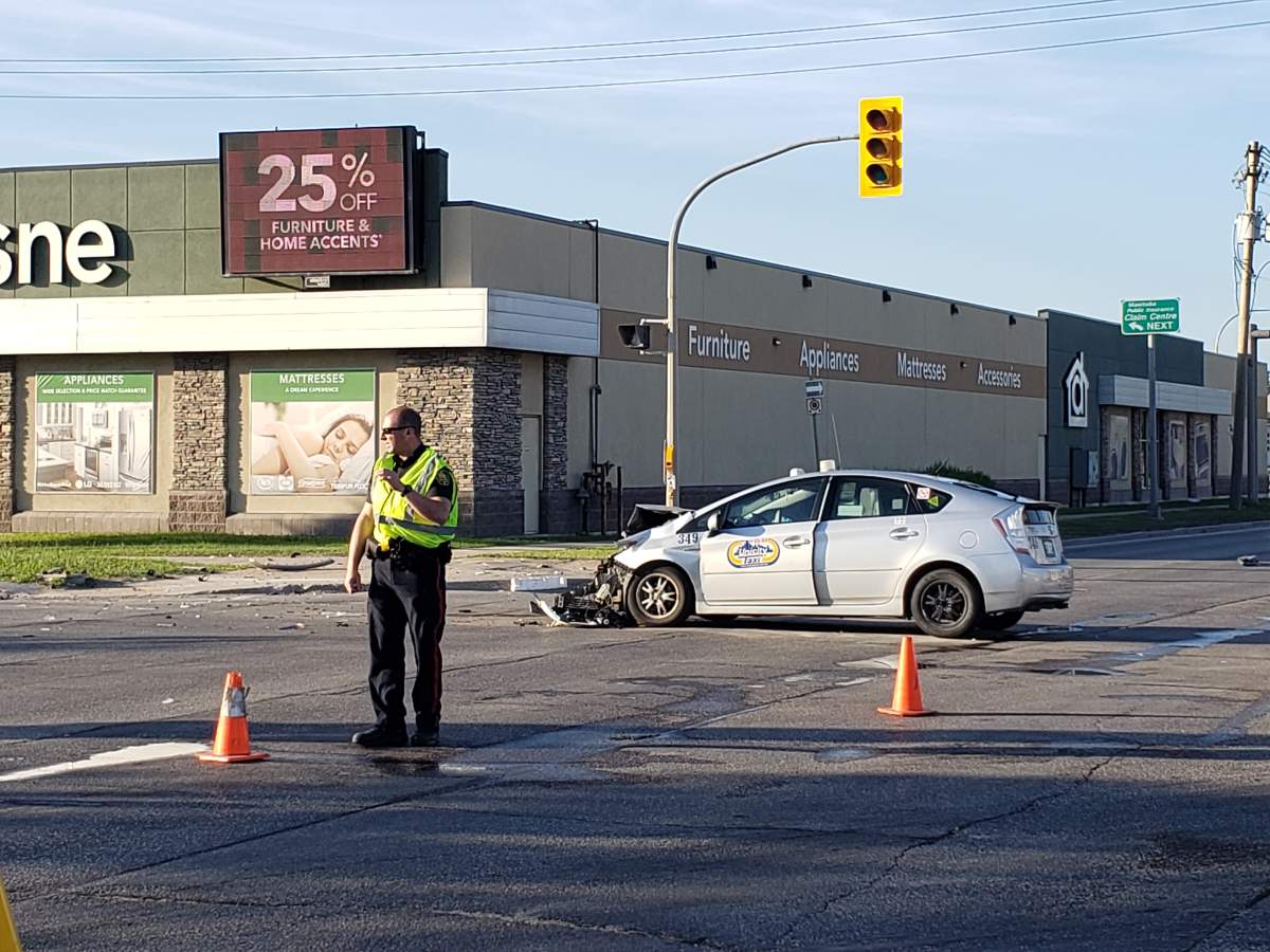 Winnipeg police direct traffic at the corner of Route 90 and Ellice Avenue Wednesday morning.