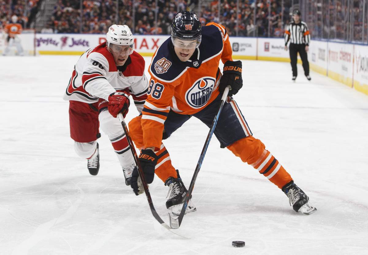Carolina Hurricanes' Teuvo Teravainen (86) chases Edmonton Oilers' Jesse Puljujarvi (98) during second period NHL action in Edmonton, Alta., on Sunday, January 20, 2019. 