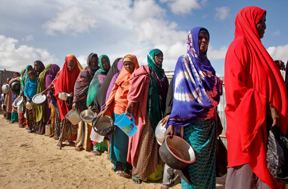  In this Saturday, May 18, 2019 file photo, newly-arrived women who fled drought line up to receive food distributed by local volunteers at a camp for displaced persons in the Daynile neighbourhood on the outskirts of the Somalian capital Mogadishu.