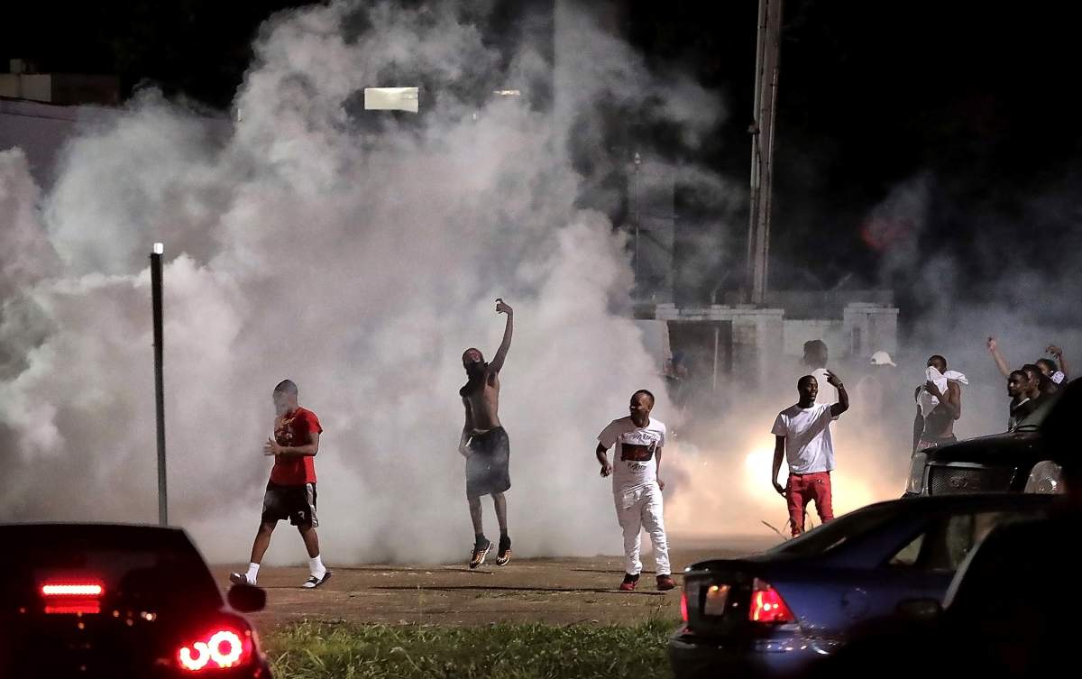 Frayser residents taunt the police as protesters take to the streets in anger against the shooting a youth identified by family members as Brandon Webber by U.S. Marshals earlier in the evening. Dozens of angry protesters clashed with police throwing stones and tree limbs until police forces broke the mob up with tear gas. ()