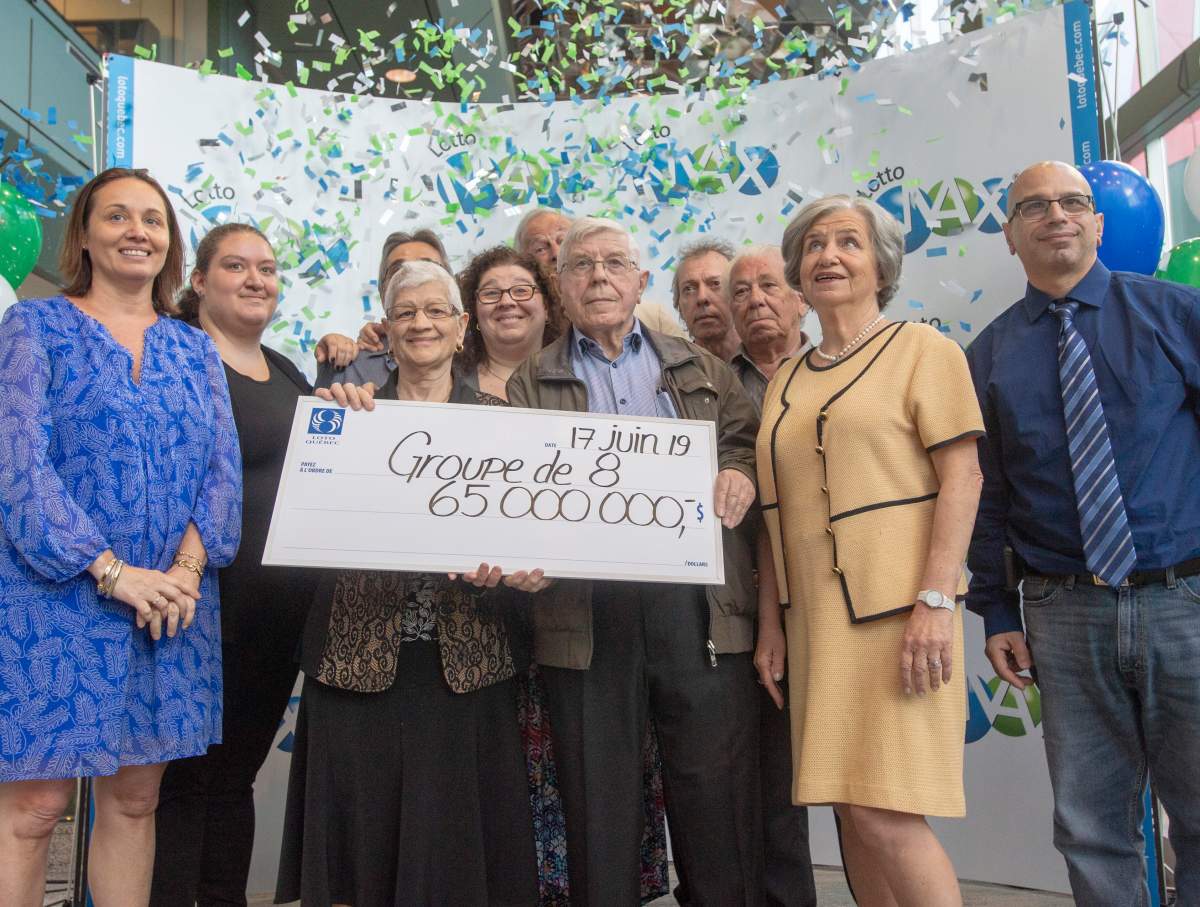 Giuseppa Lanteri and her husband, Nunzio, are surrounded by family as they receive their Canadian record $65 Million Lotto Max cheque at a ceremony Monday, June 17, 2019 in Montreal.