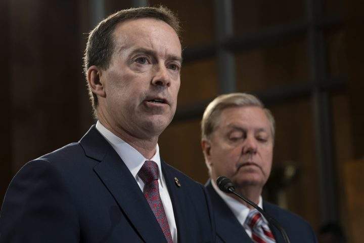 In this May 15, 2019, file photo, acting U.S. Customs and Border Protection Commissioner John Sanders, left, joins Senate Judiciary Committee Chairman Lindsey Graham, R-S.C., right, on Capitol Hill in Washington.