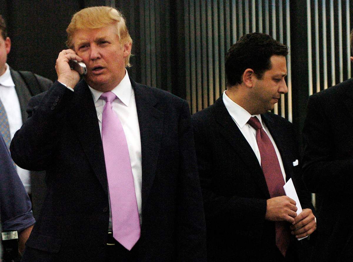 FILE - In this Sept. 14, 2005, file photo, businessman Donald Trump, left, talks on his cellphone with Felix Sater, right, outside after speaking at the Bixpo 2005 business convention at the Budweiser Events Center in Loveland, Colo.