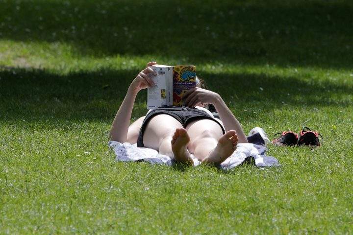 A woman sunbathes in a park in Lille, northern France. Authorities in the Paris region have issued an alert for intense heat expected in the French capital and across much of Europe this week, with meteorologists reporting the heat wave is caused by hot winds coming from the Sahara desert.