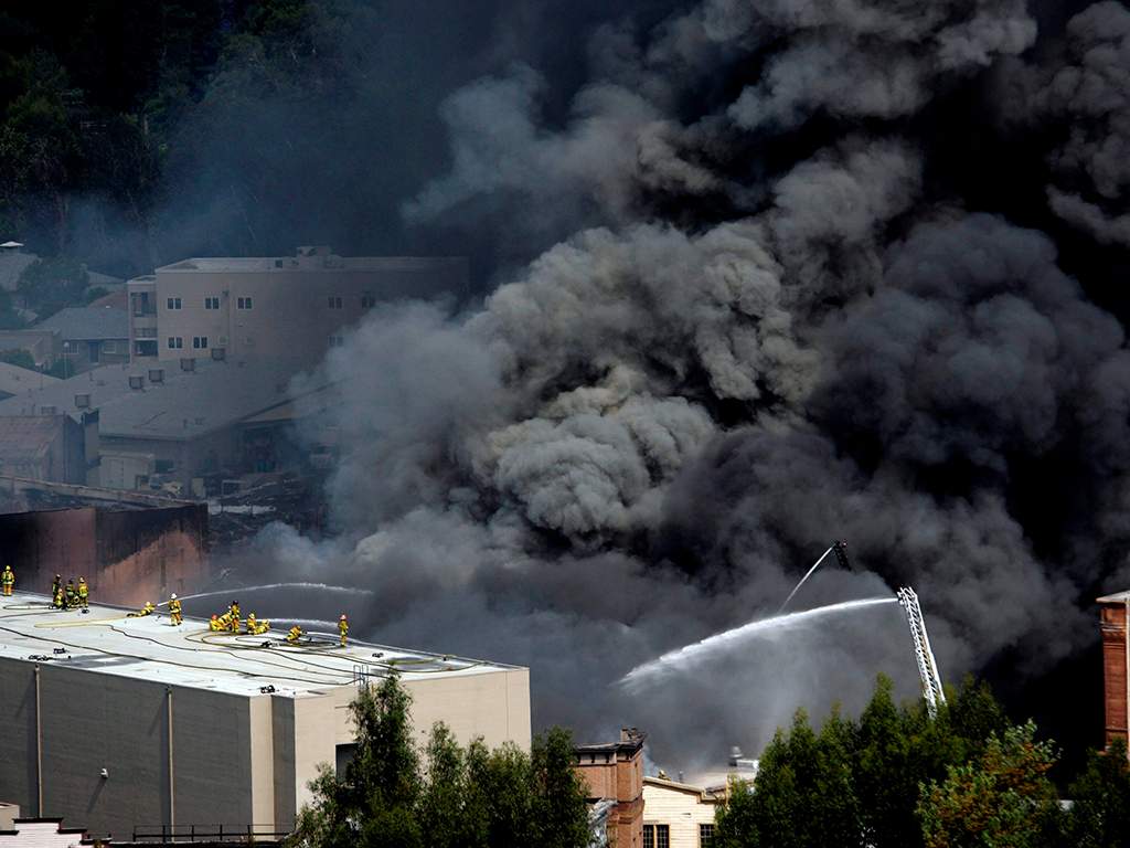 Los Angeles firefighters extinguish a fire at a building at Universal Studios in Los Angeles, Calif., on Sunday, June 1, 2008.