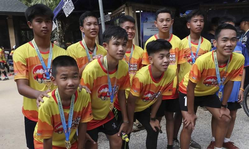 Members of the Wild Boars soccer team who were rescued from a flooded cave, pose for the media after a marathon and biking event in Mae Sai, Chiang Rai province, Thailand, Sunday, June 23, 2019.