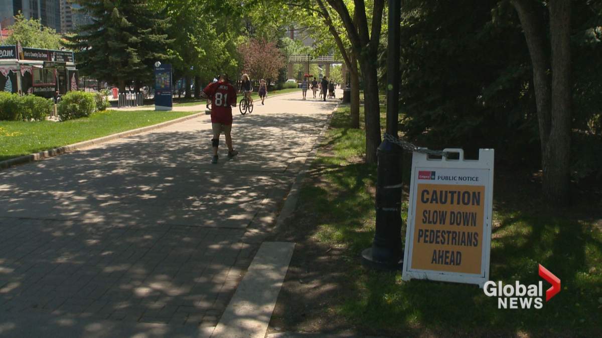 A warning sign is seen on the side of a path at a Calgary park.