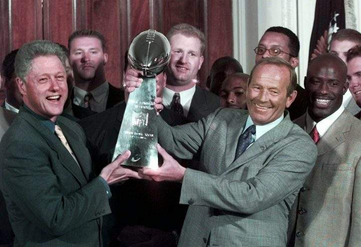 In this June 16, 1998, file photo, then President Clinton, left, and Denver Broncos owner Pat Bowlen hold the Vince Lombardi Trophy during a ceremony at the White House where the president honored the Super Bowl XXXII champions