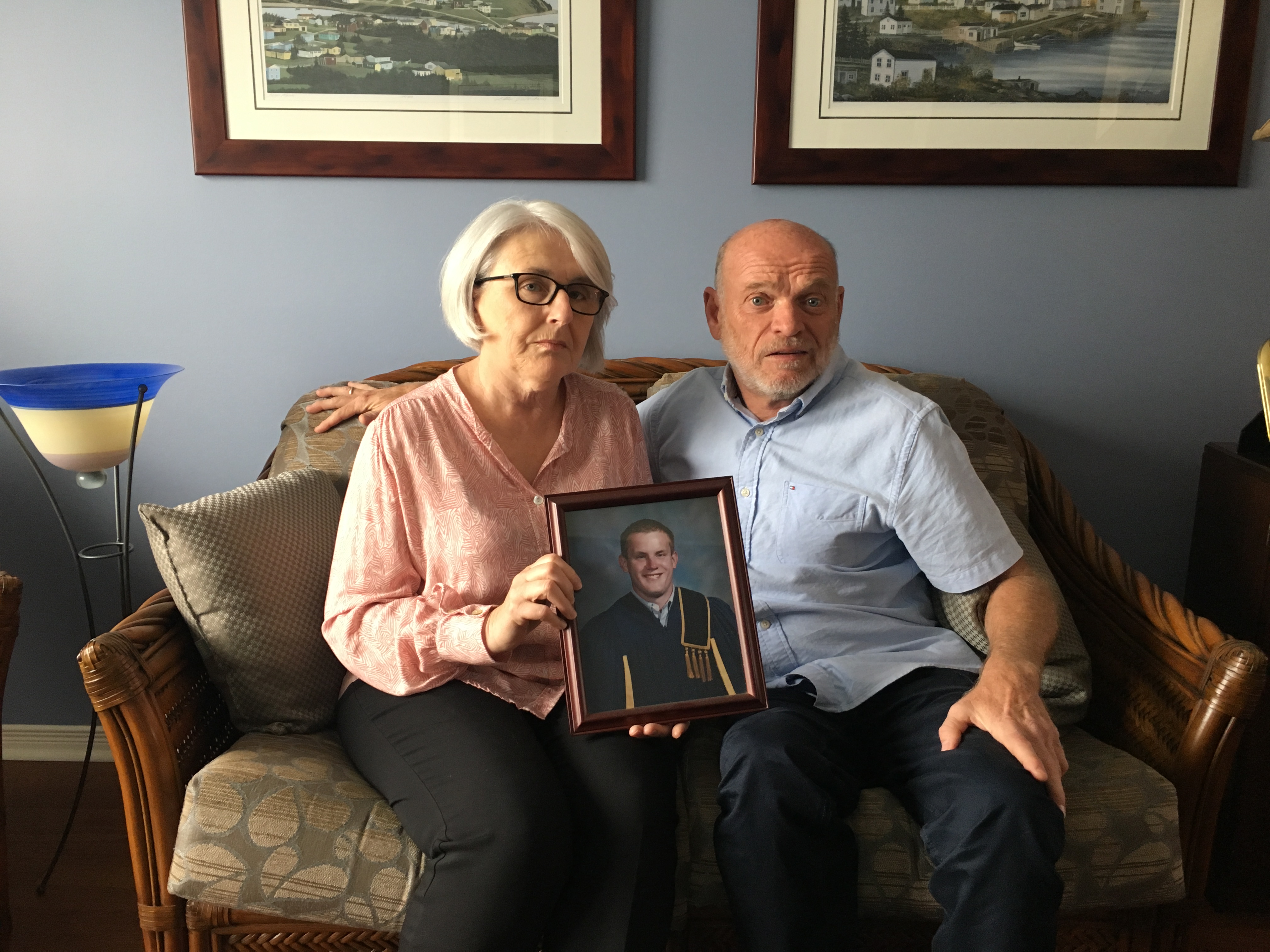Jill Broadbent and Derek Fudge sit on the couch in their home near Ottawa.