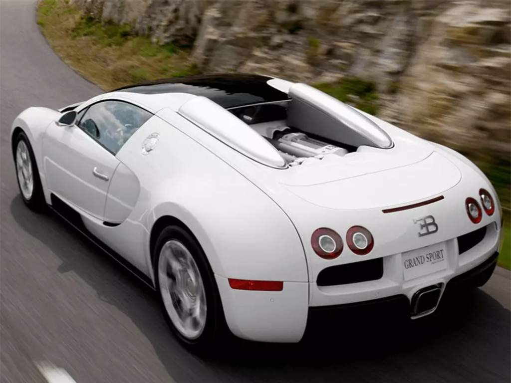 A Veyron 16.4 Grand Sport model Bugatti driving along a mountainside.