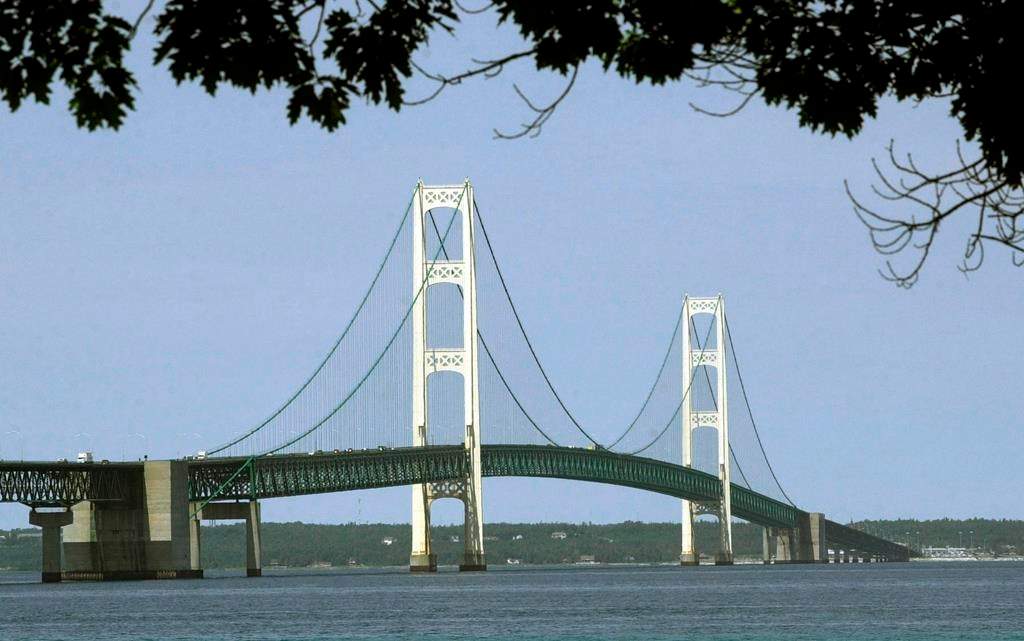 FILE - This July 19, 2002, file photo, shows the Mackinac Bridge that spans the Straits of Mackinac from Mackinaw City, Mich. Enbridge Inc. said Monday, June, 17, 2019, it‚Äôs moving ahead with collection of rock and soil samples in the Straits of Mackinac while preparing for a court battle with Michigan‚Äôs governor over a planned oil pipeline tunnel there. The Canadian company, which has been drilling into the ground on the south side of the channel linking Lakes Huron and Michigan, said it will begin boring into the lakebed this week from a barge in shallow water.