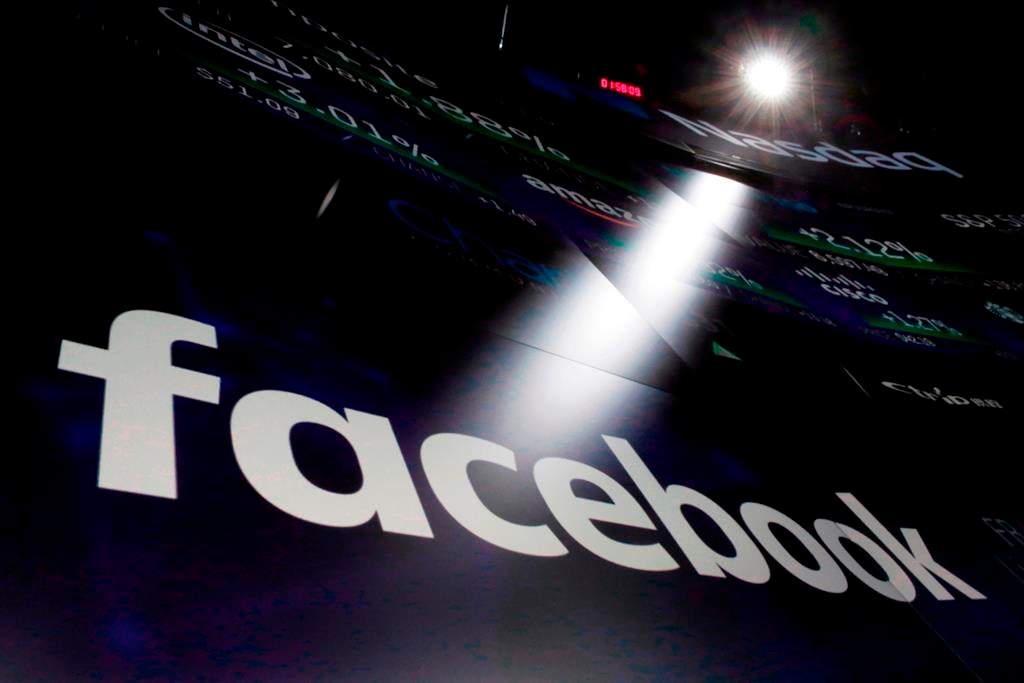 In this March 29, 2018, file photo, the logo for Facebook appears on screens at the Nasdaq MarketSite in New York's Times Square. THE CANADIAN PRESS/AP/Richard Drew, File.