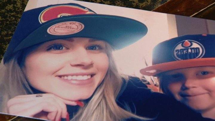 A family photo of Demi McKechnie taken after giving her nephew an Edmonton Oilers cap, taken about one month before her death.