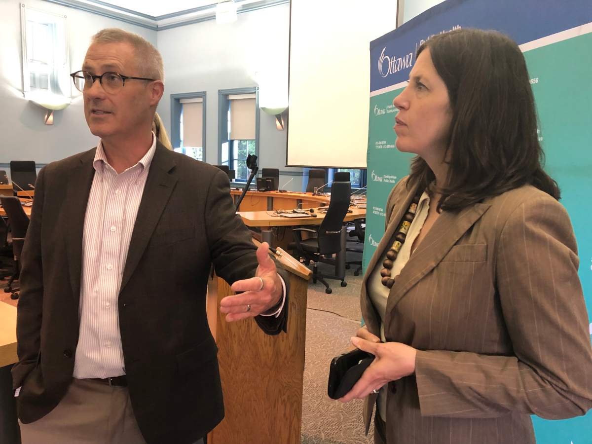 Coun. Keith Egli, chair of the Ottawa Public Health board, and Dr. Vera Etches, Ottawa's medical offer of health, speak to reporters at city hall on Monday, June 17, 2019.