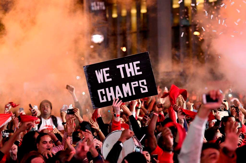 Toronto Raptors fans react at Jurassic Park, outside of the Scotiabank Arena in Toronto, as they watch the Raptors defeat the Golden State Warriors in Game 6 of the NBA Finals to win the NBA Championship, Thursday, June 13, 2019.