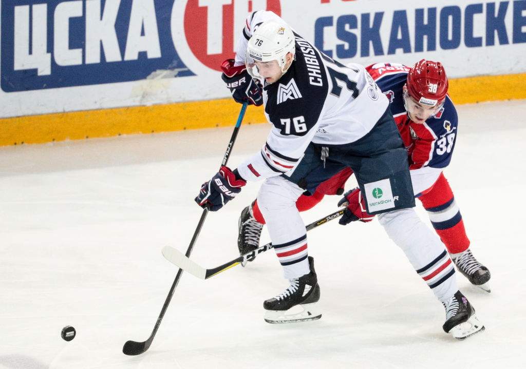 Metallurg Magnitogorsk's Andrei Chibisov (L) and CSKA Moscow's Mikhail Naumenkov fight for the puck in their 2017/18 KHL Regular Season ice hockey match at CSKA Arena.
