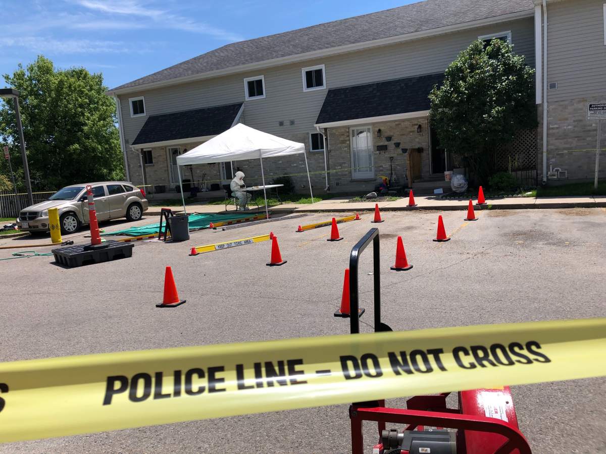 An authority dressed in hazmat sits outside a Hamilton Road under investigation for what police believe to be is a drug lab inside.