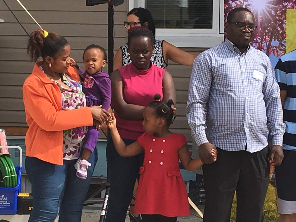 Theogene and Solange Buhelwa with their children, Ange, Rosine, and Melissa.
