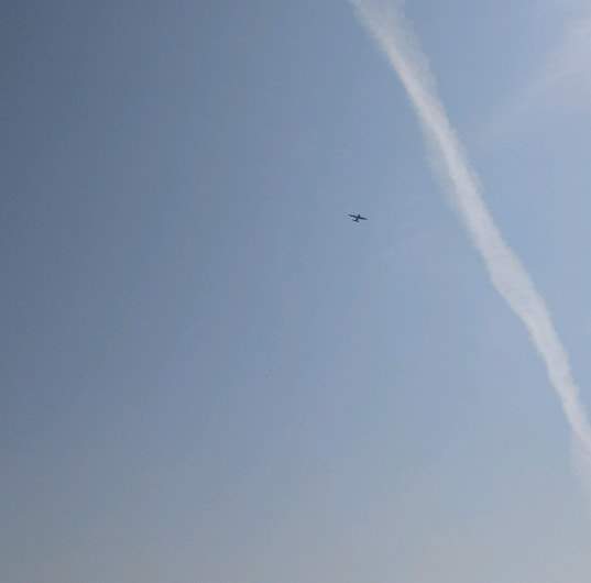 A military plane is seen flying over the Irvine, Alta., area as emergency officials investigate a fatal plane crash on Sunday, June 2.