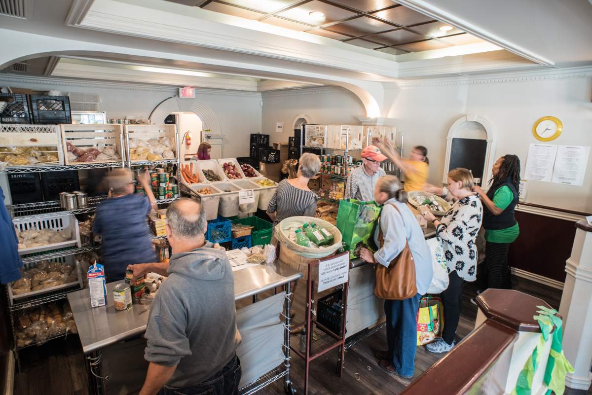 Volunteers at The Depot Community Food Centre serve a selection of healthy foods to community members.