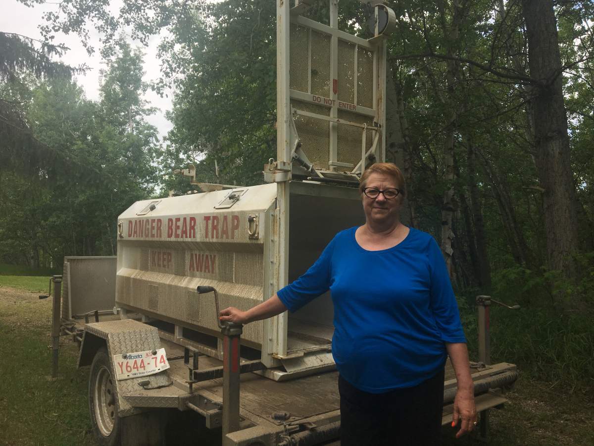 Fish and Wildlife officers set up a bear trap on Joan Wakelam’s Sturgeon County property.