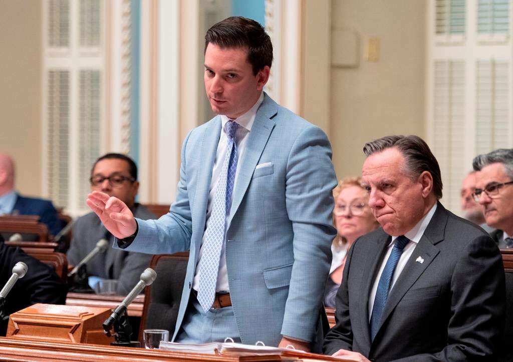 Quebec government House Leader Simon Jolin-Barrette responds to the Opposition during question period Friday, June 14, 2019 at the legislature in Quebec City. Francois Legault, right, looks on.