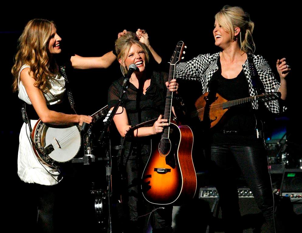 Emily Strayer, left, and Martie Maguire, right, adjust Natalie Maines’ hair as the Dixie Chicks perform at the new Nokia Theatre in Los Angeles in 2007. The award-winning group took to Instagram on Tuesday, June 25, 2019 to tease a new album. It would be their first in 13 years. (AP Photo/Gus Ruelas, file)