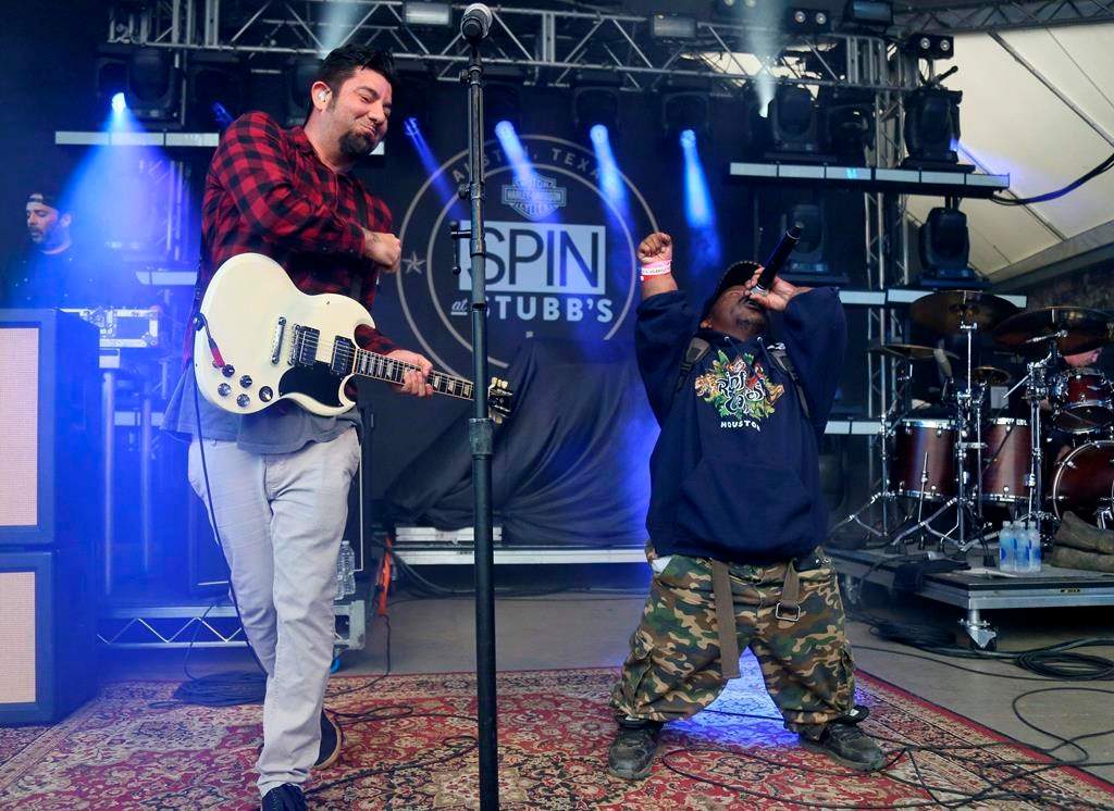 In this March 18, 2016, photo Bushwick Bill, right, joins Deftones’ Chino Moreno onstage at the SPIN Party at Stubb’s during the South by Southwest Music Festival in Austin, Texas. Representatives of pioneering rapper Bushwick Bill say he is hospitalized in critical condition but still alive, contrary to some reports. (Photo by Jack Plunkett/Invision/AP, File)