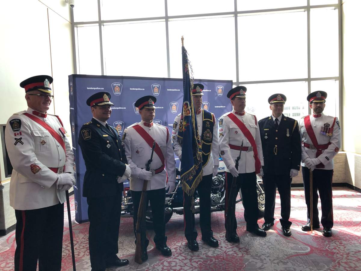 Retired Chief of Police John Pare, left in black, stands with senior officers and London's new Chief of Police Steve Williams, right in black.