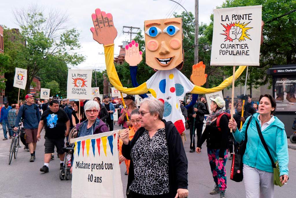 Community groups march in the Montreal district of Pointe-Saint-Charles on Thursday, June 13, 2019.