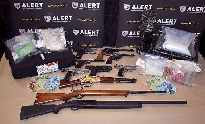 Seven people are facing more than 175 charges after 12 guns and nearly $200,000 worth of drugs were seized from a rural property in Peace River, Alta.