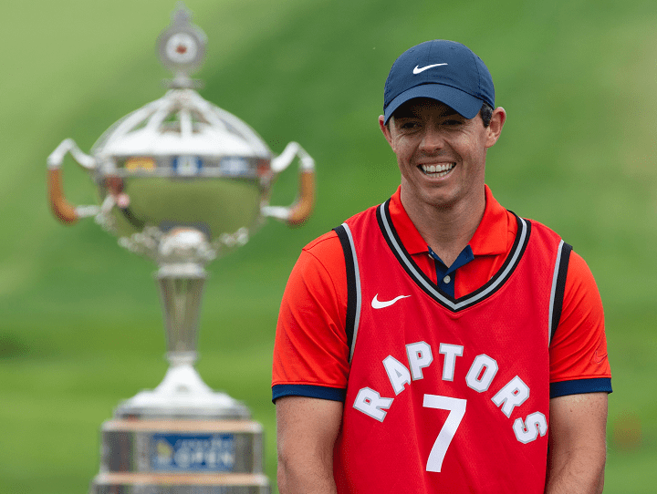 Rory McIlroy laughs as he puts on a Toronto Raptors jersey during the trophy presentation at the Canadian Open golf championship in Ancaster, Ont., on Sunday.