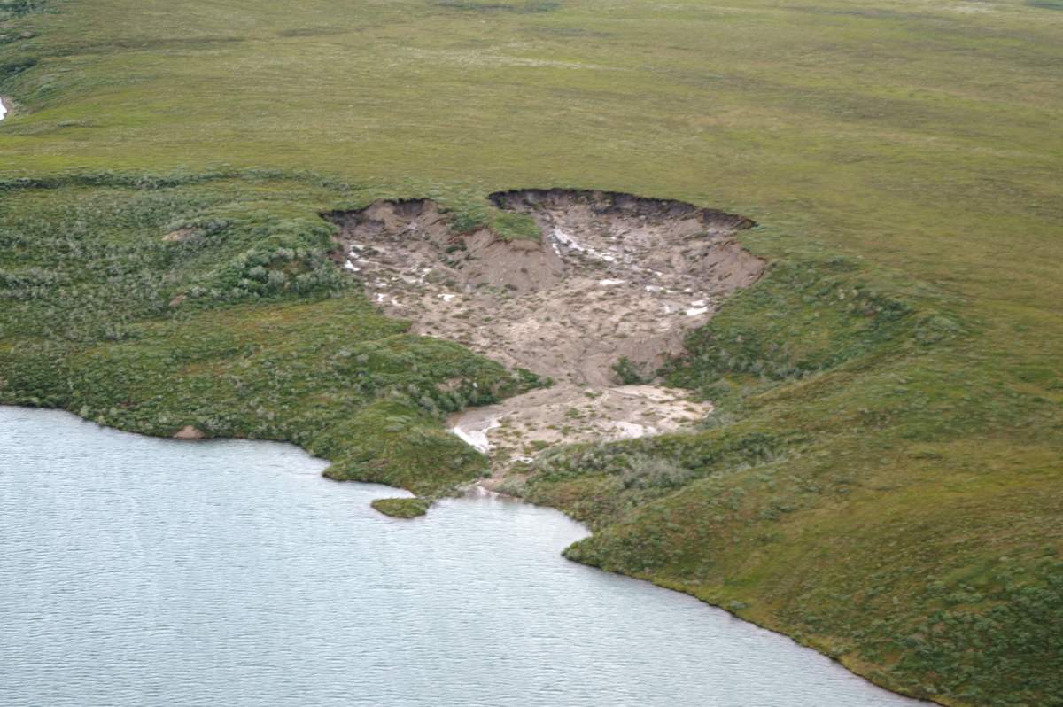 An aerial view of a thermokarst, a section of land that caved in after frozen soil below the ground thawed, is seen here at Toolik Lake, Alaska.