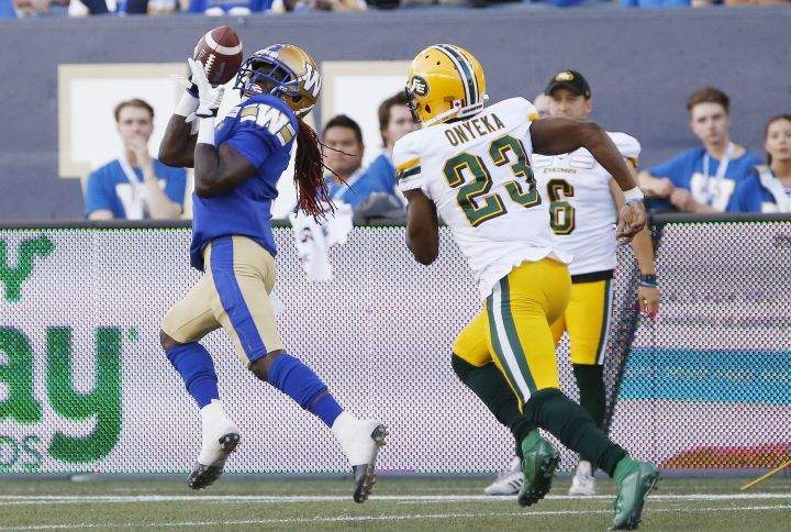 Edmonton Eskimos' Godfrey Onyeka (23) can't stop Winnipeg Blue Bombers' Lucky Whitehead (7) as he hauls in the pass and runs it in for the touchdown during the first half of CFL action in Winnipeg Thursday, June 27, 2019. 