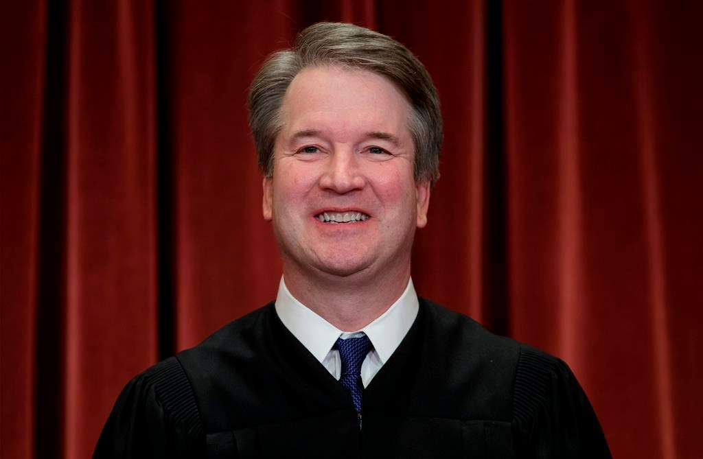 In this Nov. 30, 2018, file photo Associate Justice Brett Kavanaugh sits with fellow Supreme Court justices for a group portrait at the Supreme Court Building in Washington.