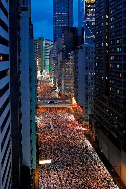 Protesters march in a rally against the proposed amendments to an extradition law in Hong Kong, Sunday, June 9, 2019.