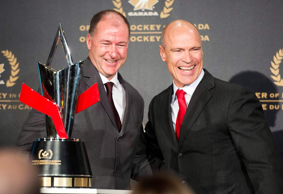 Former Edmonton Oilers’ teammate Kevin Lowe (left) was on hand to induct Mark Messier into the Order of Hockey in Canada during a ceremony on Parliament Hill in Ottawa, Monday April 8, 2013. T