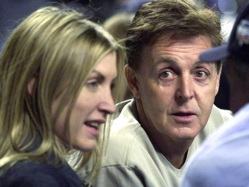 Paul McCartney, centre, and his ex-wife Heather Mills chat before the Seattle Mariners and New York Yankees play in Game 4 of the American League Championship at Yankee Stadium Sunday, Oct. 21, 2001 in New York City.
