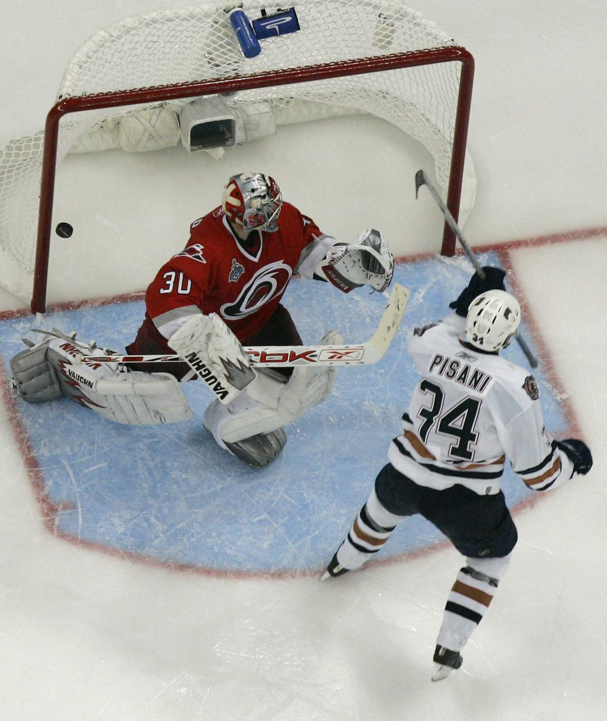 Edmonton Oilers’ Fernando Pisani (34) makes the game-winning goal in overtime against Carolina Hurricanes goalie Cam Ward during Game 5 of the Stanley Cup hockey finals on Wednesday, June 14, 2006 in Raleigh, N.C. Edmonton won 4-3.