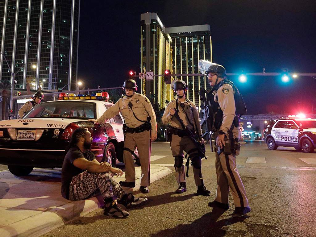 In this Oct. 1, 2017 file photo, police officers stand at the scene of a shooting near the Mandalay Bay resort and casino on the Las Vegas Strip in Las Vegas, Nev.