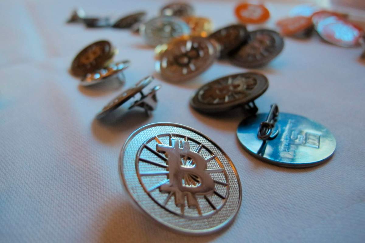 FILE-In this Feb. 12, 2014 file photo Bitcoin buttons are displayed on a table at the Inside Bitcoins conference in Berlin.