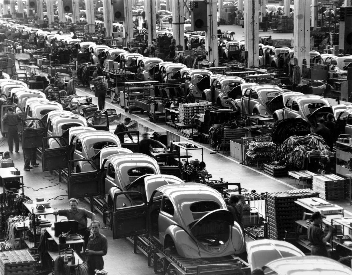In this June 16, 1954 file photo, VW beetles are assembled in lines at the Volkwagen auto works plant, which manufactures nearly 900 automobiles each day, in Wolfsburg, West Germany. Volkswagen is halting production of the last version of its Beetle model in July 2019 at its plant in Puebla, Mexico.