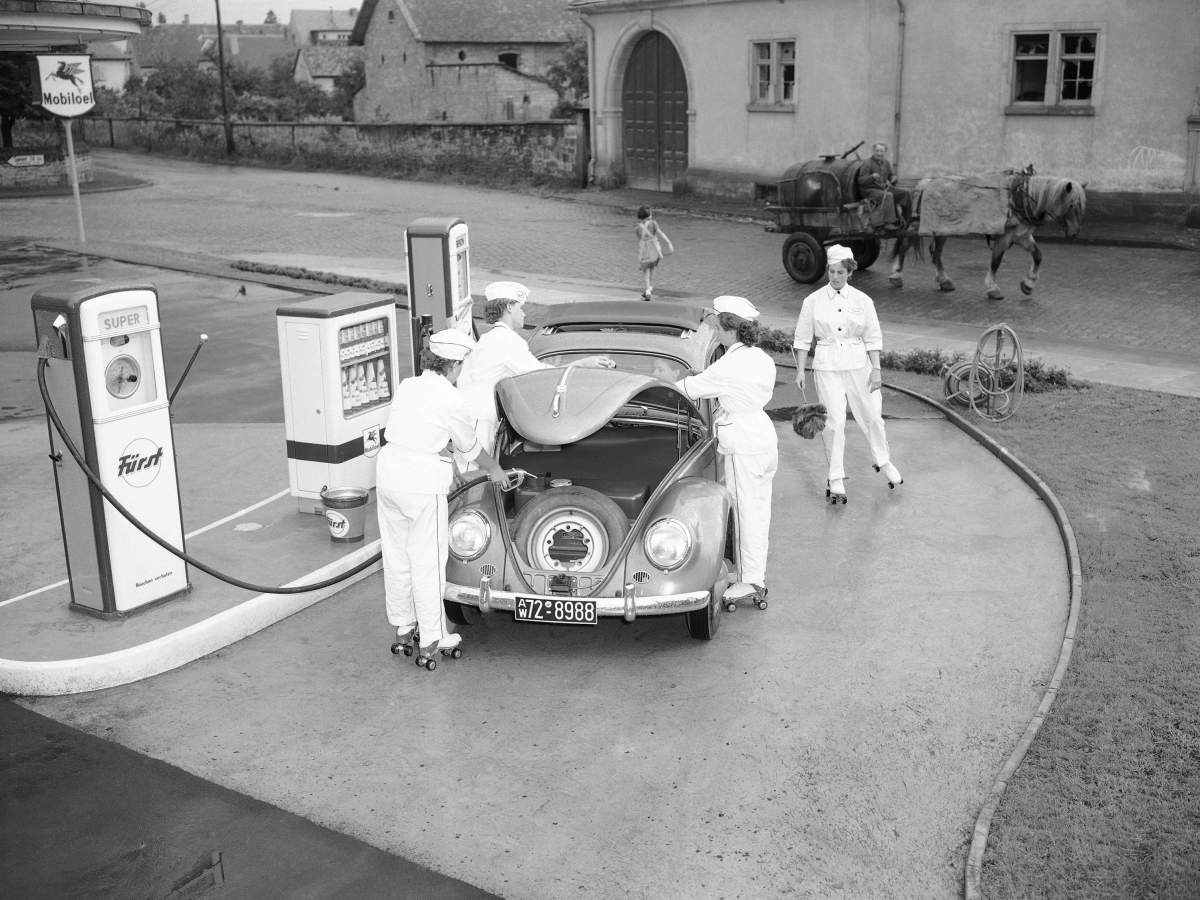 In this Aug. 23, 1954 file photo, four female employees tend to a Volkswagen at a gas station in Deidesheim, near Kaiserslautern, Germany.